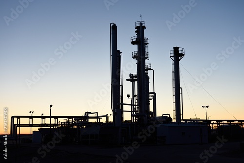 Dawn silhouette of pipes and towers at a natural gas processing facility near Casper, Wyoming