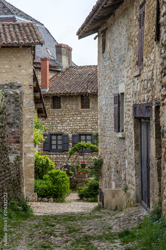 A Glimpse Into a Stone Courtyard Between Stone Buildings in Perouges, France