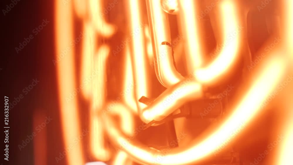 A red neon sign of a kanji character.