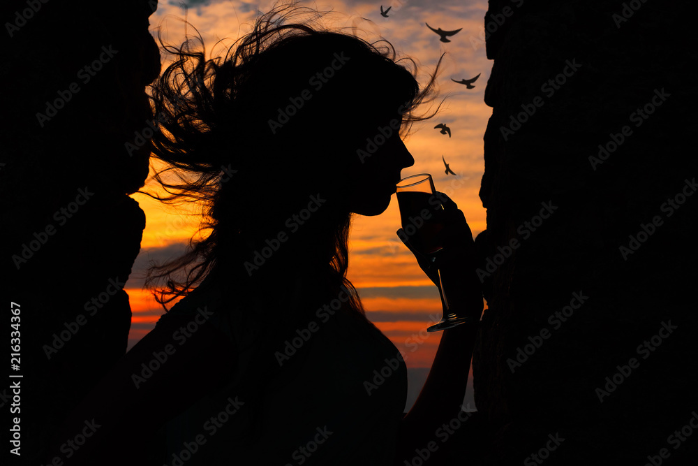 woman with flying hair at sunset