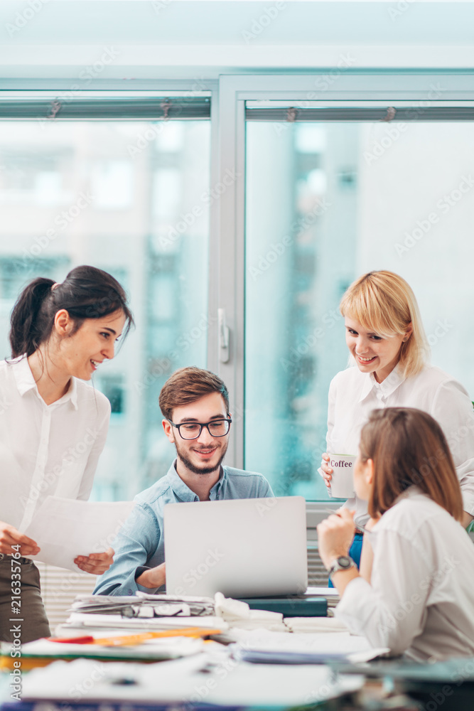 © Suteren Studio - Colleagues Discussing Project at the Office