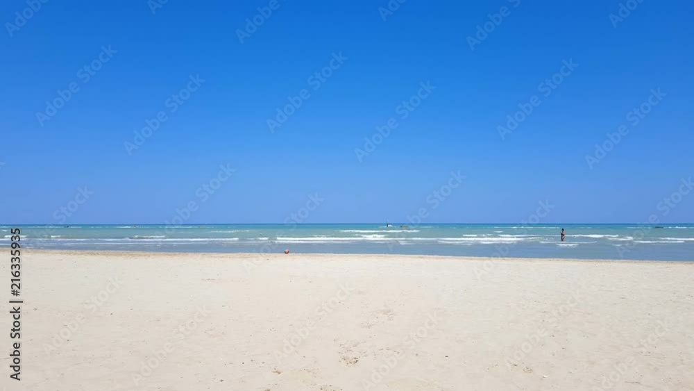 Desert italian beach with a woman in background Desert italian beach with a woman in background