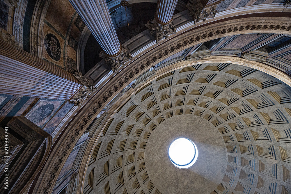 Looking up at the shaft of light coming through the oculus in the Pantheo, Rome