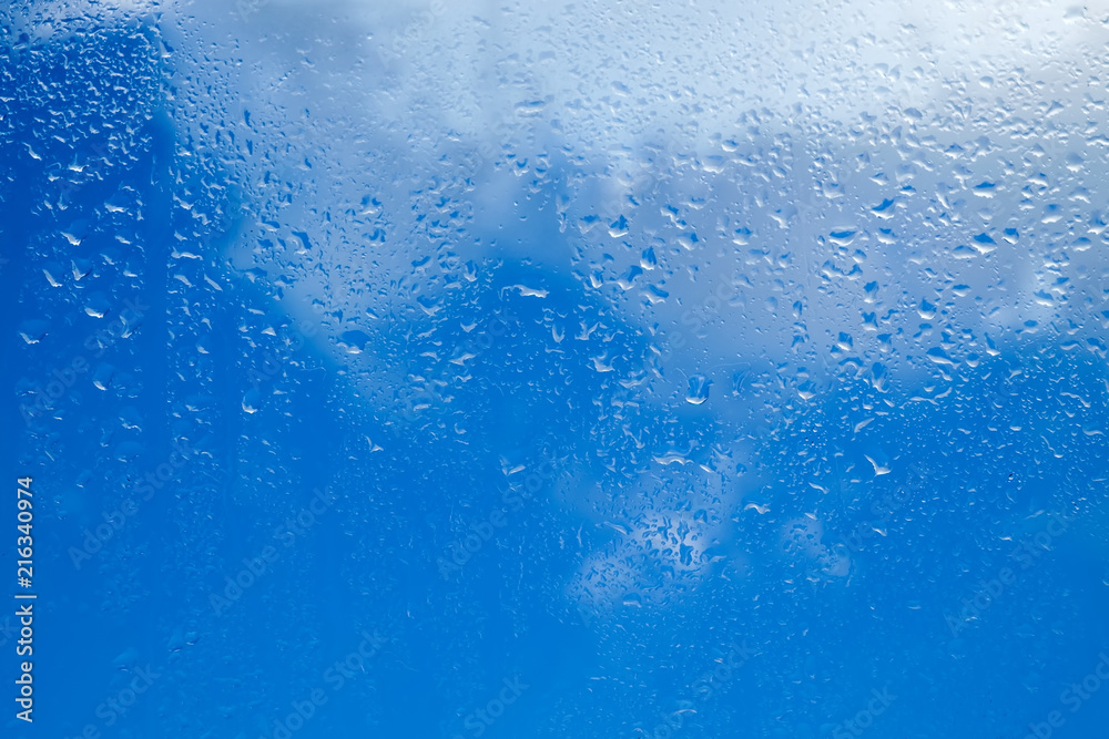 Drops of water on a glass against a cloudy sky background. Seamless texture Drops of water on a glass against a cloudy sky background. Seamless texture