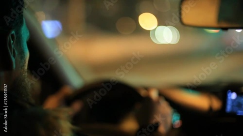 Man rides a car with a navigator on a smartphone