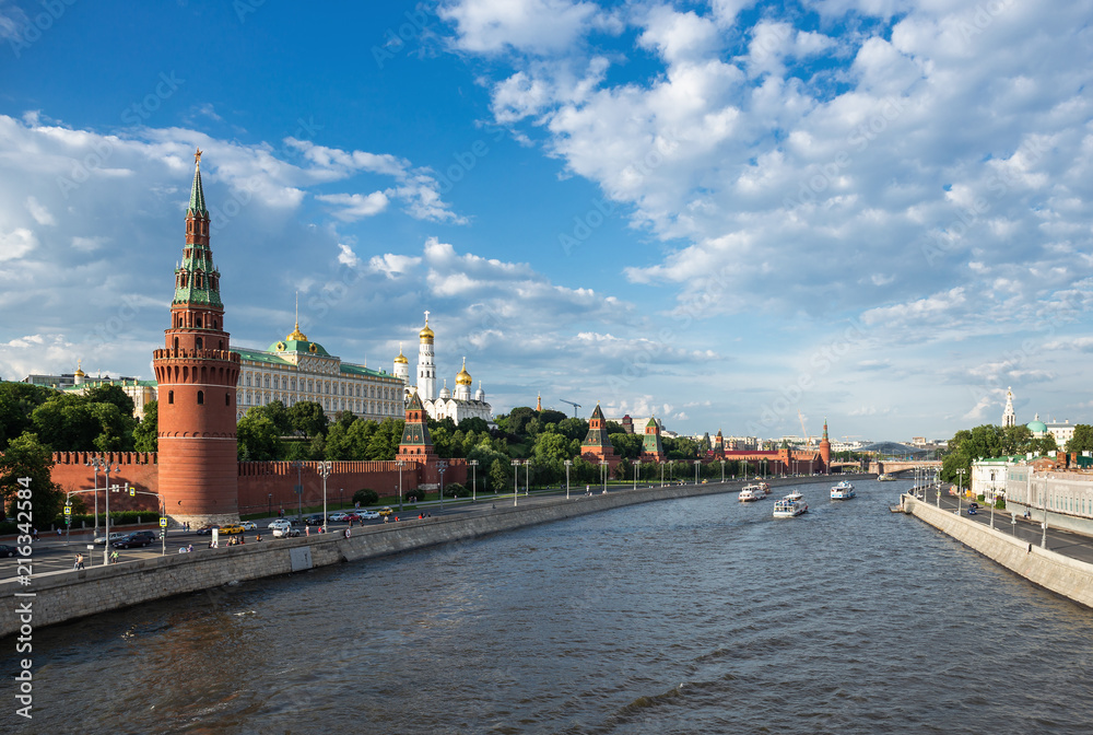 View of the river Moscow with walking ship, Kremlevskaya Embankment and towers of the Moscow Kremlin