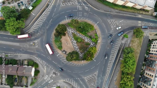 Top down aerial drone footage of a medium sized roundabout in Romford with traffic which moves through and around the roundabout photo