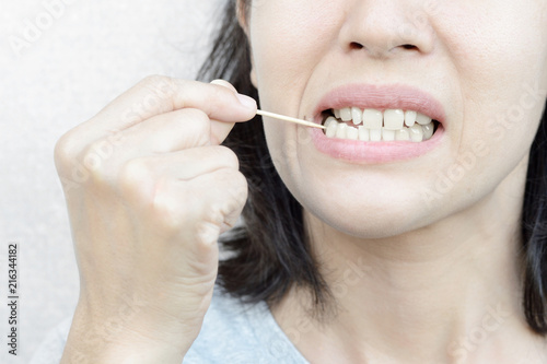 woman use wooden toothpick