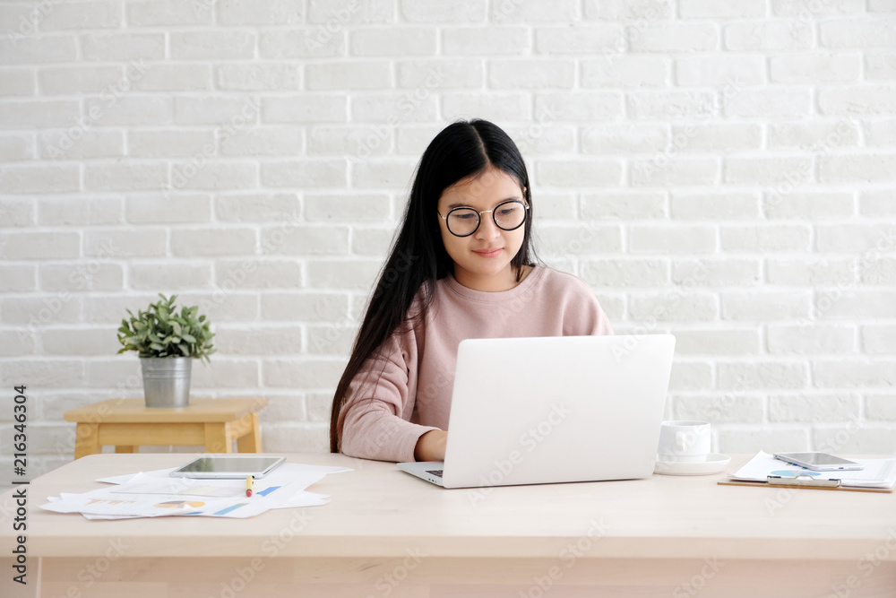 Young asian woman working with laptop computer at home office with happy emotion, working from home, small business, office casual lifestyle concept Young asian woman working with laptop computer at home office with happy emotion, working from home, small business, office casual lifestyle concept