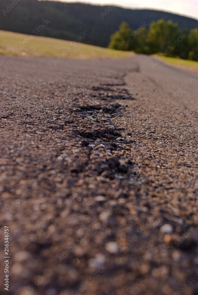 marks in the asphalt of a small rural road marks in the asphalt of a small rural road