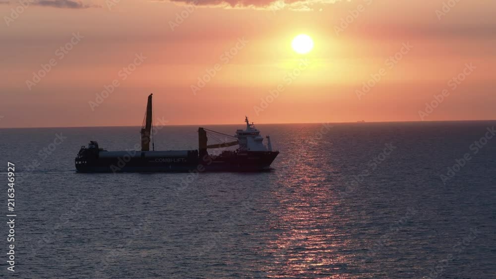 A Heavy Lift Carrier Sailing at Sunset A Heavy Lift Carrier Sailing at Sunset