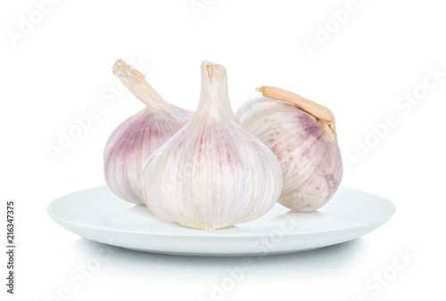 garlic in white plate on white background