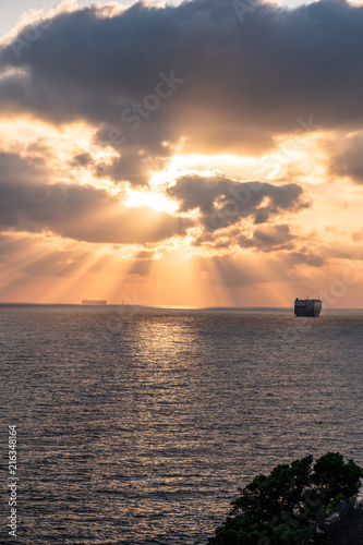 barche che vanno verso il porto di Livorno al tramonto photo