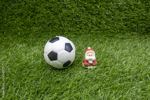 Merry Christmas to golfer with Santa and football on green grass © thaninee