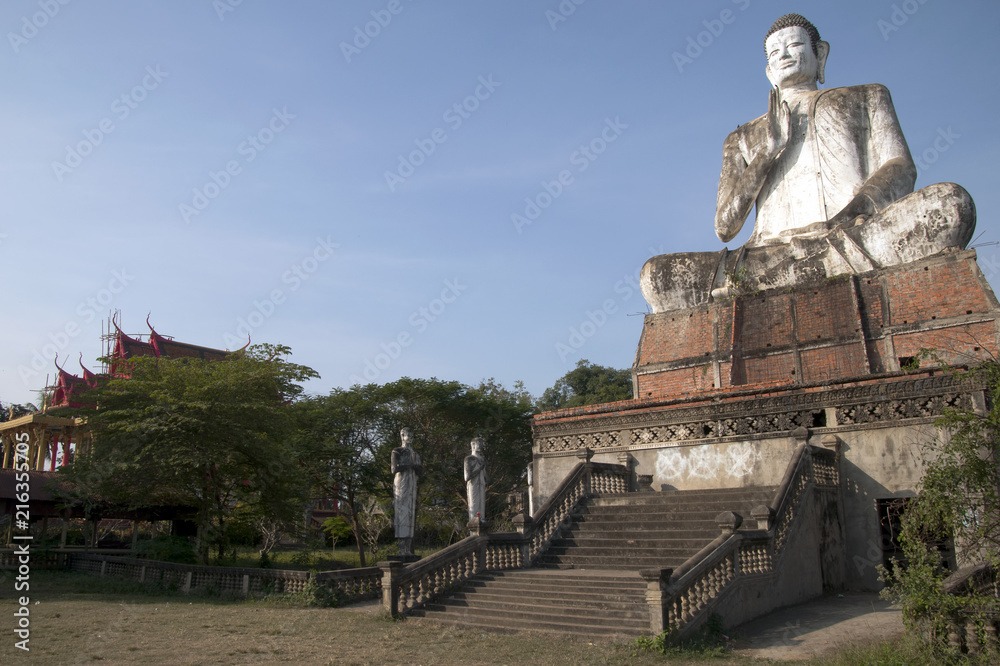 Battambang Cambodia, giant buddha statue with Ek Phnom buddhist temple in background
