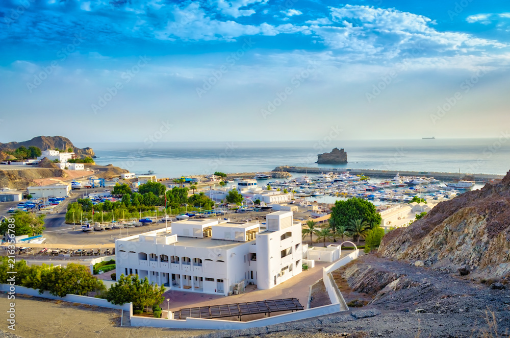 Top view of Oman seascape with blue sky and mountains.