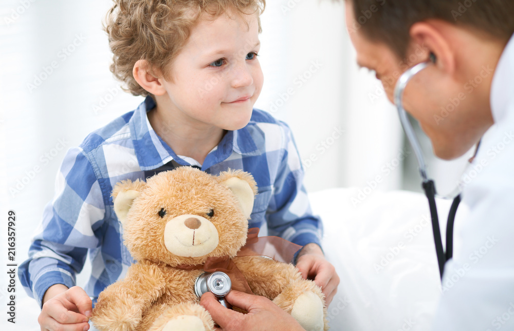 Doctor and child patient. Physician examines little boy by stethoscope. Medicine and children's therapy concept Doctor and child patient. Physician examines little boy by stethoscope. Medicine and children's therapy concept