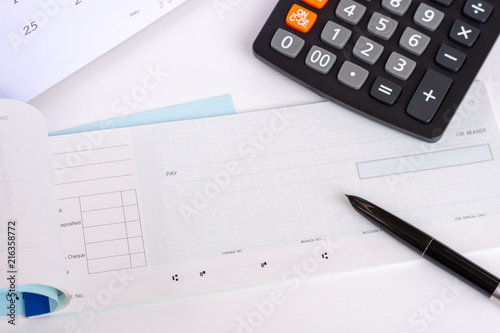 Checkbook, calendar and calculator on the white background. Payday concept.