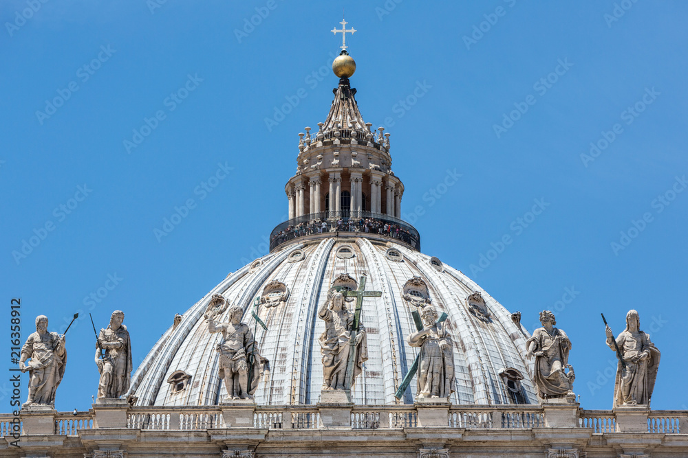 The dome of St Peter's Basilica in Rome showing the top viewing platform and stunning sculptures