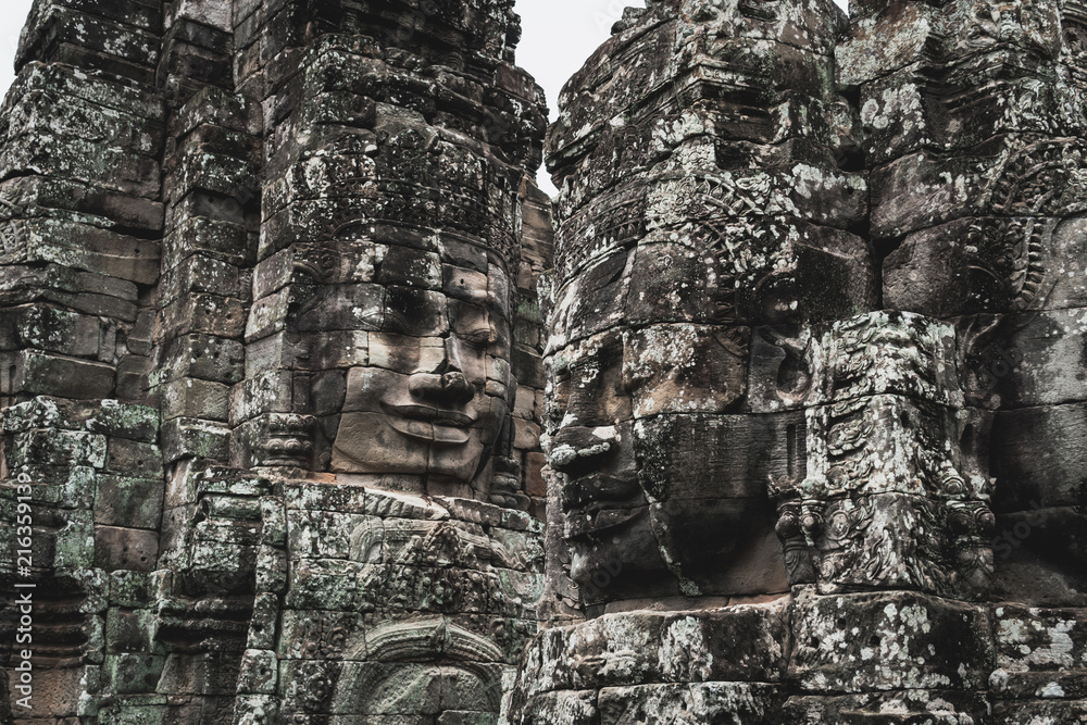 Faces of Bayon temple in Angkor Thom, The Bayon's most distinctive feature is the multitude of serene and smiling stone faces on the many towers