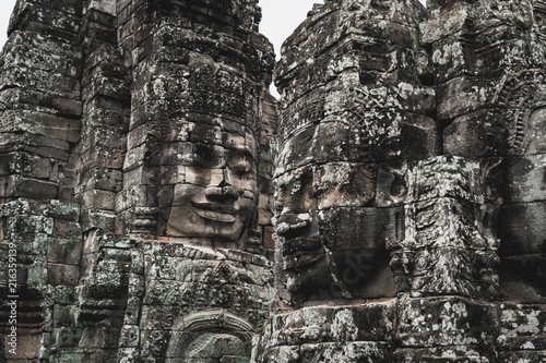 Faces of Bayon temple in Angkor Thom, The Bayon's most distinctive feature is the multitude of serene and smiling stone faces on the many towers