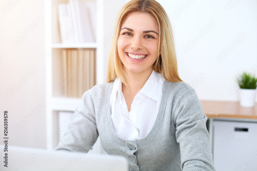 Young business woman or student girl working at office workplace with laptop computer Young business woman or student girl working at office workplace with laptop computer