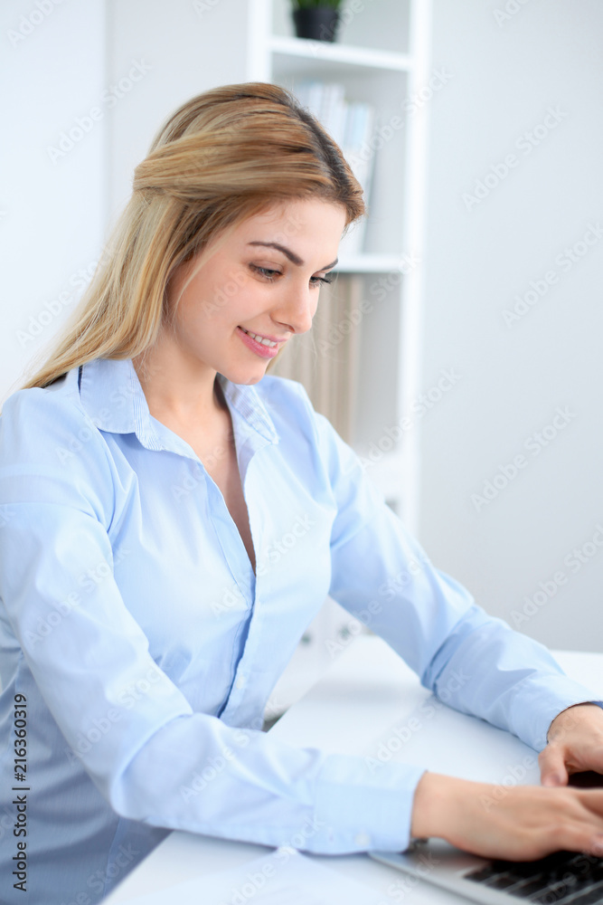 Young business woman or student girl working at office workplace with laptop computer Young business woman or student girl working at office workplace with laptop computer