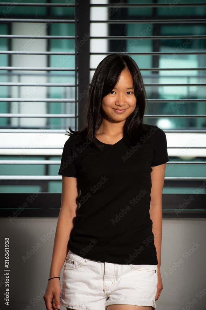 Beauty portrait of asian woman in a black shirt and white jean shorts Stock  Photo | Adobe Stock