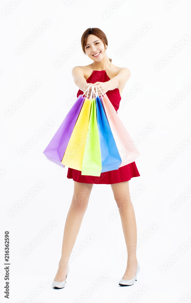 Happy young Woman showing shopping bags