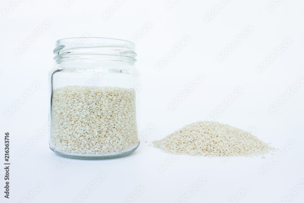 white sesame seed in jar on white background white sesame seed in jar on white background