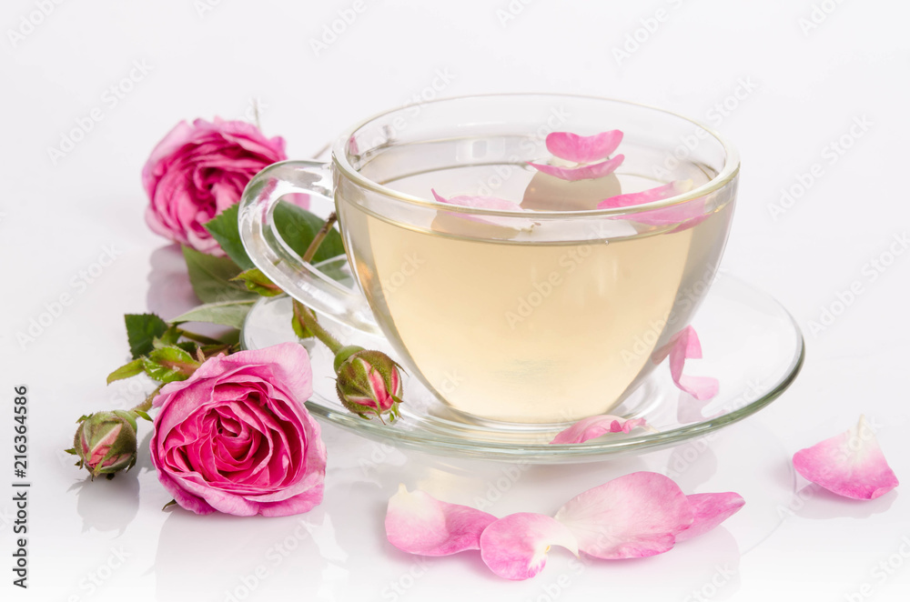 Glass cup of Tea with roses and petals Glass cup of Tea with roses and petals