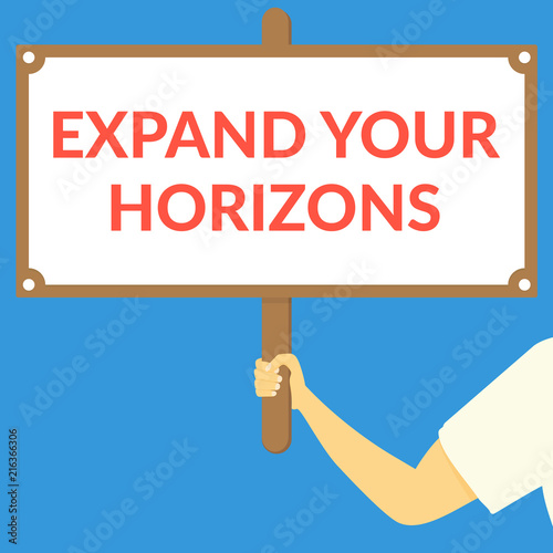 EXPAND YOUR HORIZONS. Hand holding wooden sign