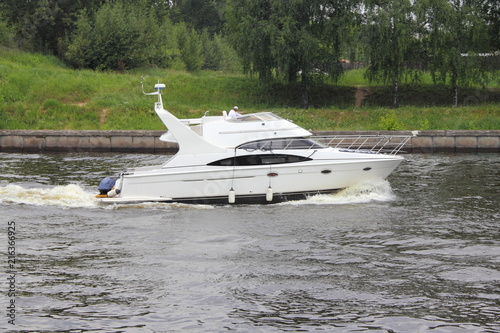 Fotografija Travel, luxury water recreation on boat - a white motor yacht with radar on the