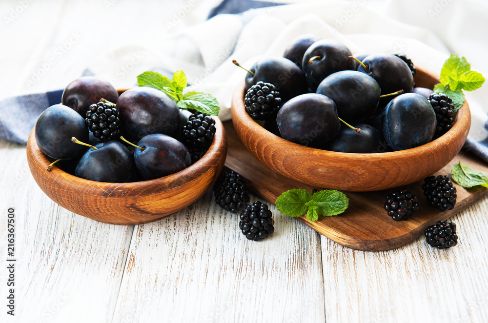Bowls with fresh plums Bowls with fresh plums