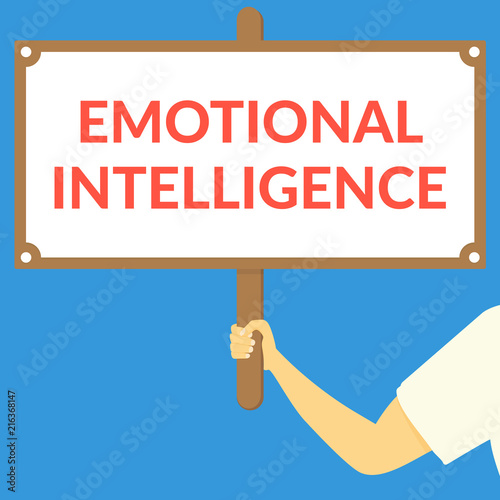 EMOTIONAL INTELLIGENCE. Hand holding wooden sign