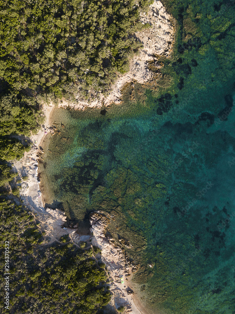 View from above, aerial view of a rocky coast bathed by an emerald and transparent Mediterranean sea, Costa Smeralda, Sardinia, Italy