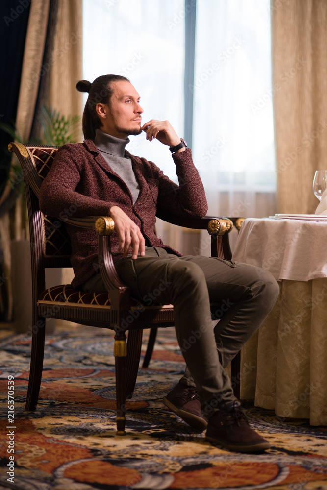 man in the room sitting in a chair man in the room sitting in a chair