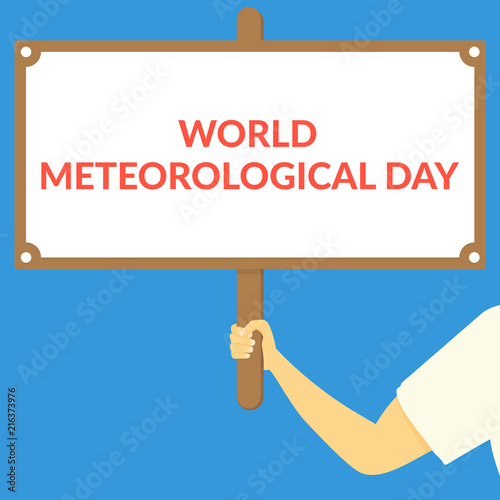 WORLD METEOROLOGICAL DAY. Hand holding wooden sign