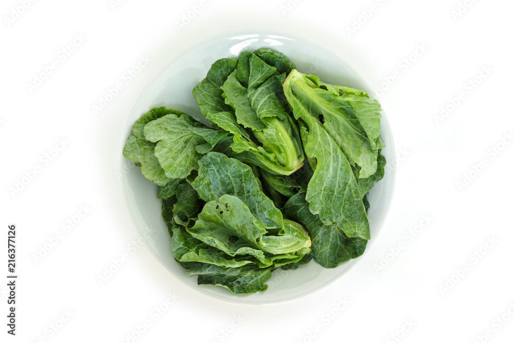 chinese kale on plate top view on white background chinese kale on plate top view on white background
