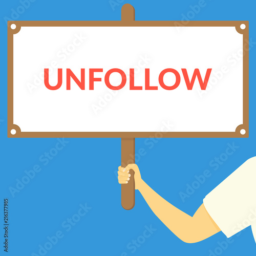 UNFOLLOW. Hand holding wooden sign