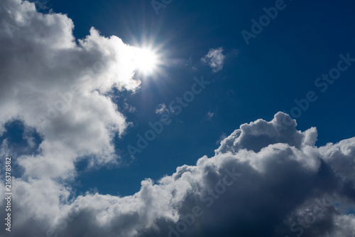 Clouds and bright sun in the wonderful blue sky