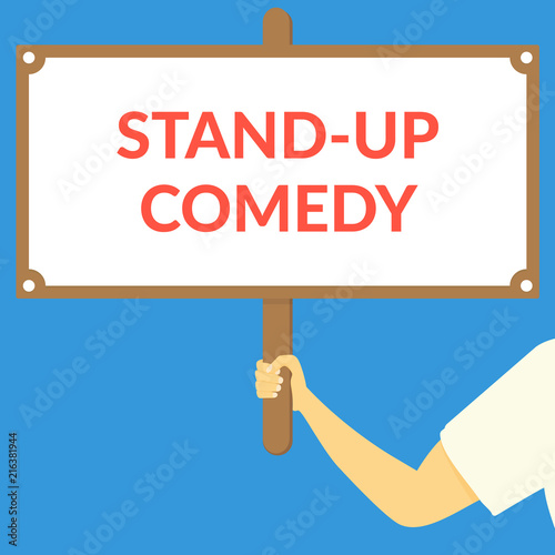 STAND-UP COMEDY. Hand holding wooden sign