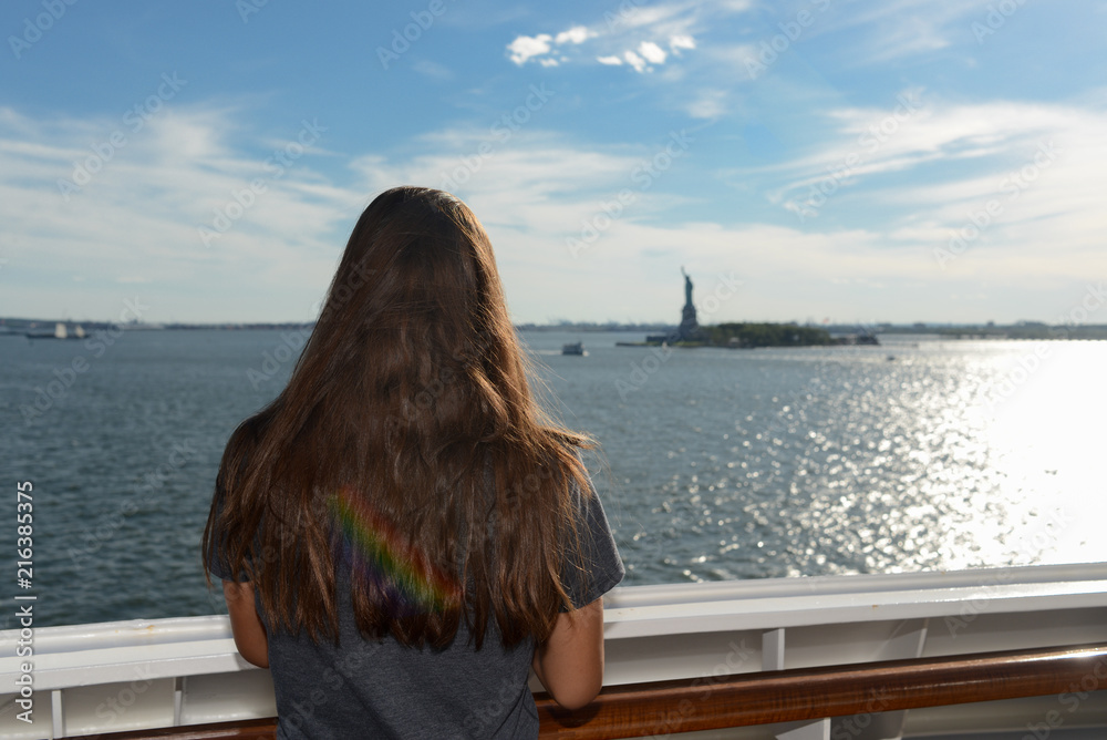 Girl watching the Statue of Liberty go by