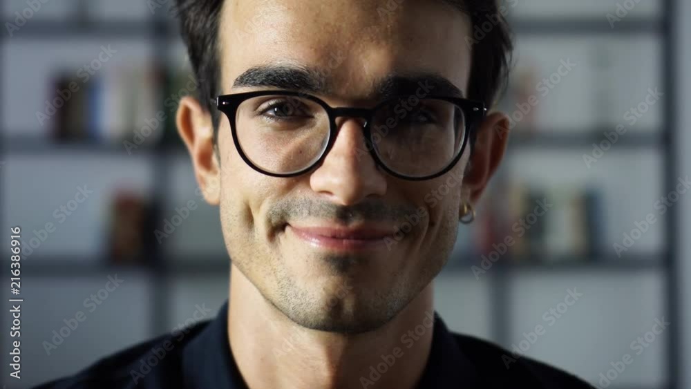 Portrait of Happy Satisfied Student in the Library Looking at the Camera, Man in Glasses, University, College, Success Portrait of Happy Satisfied Student in the Library Looking at the Camera, Man in Glasses, University, College, Success