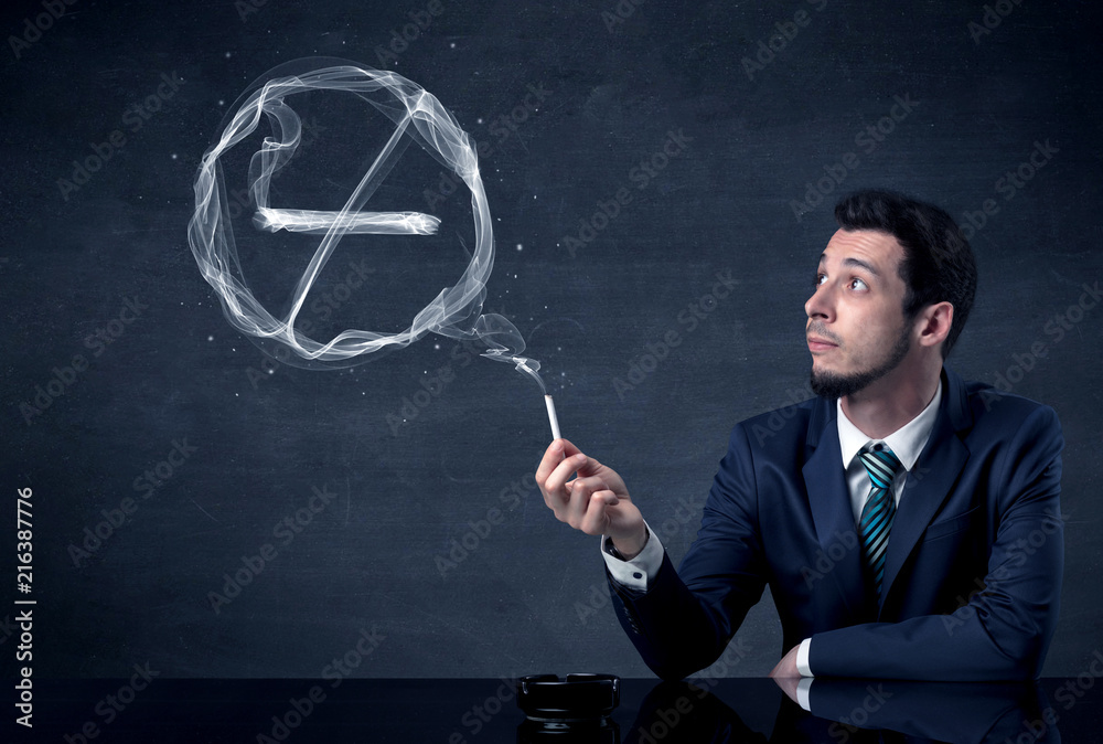 Businessman smoking cigarette and the smoke forms a no smoking sign. Businessman smoking cigarette and the smoke forms a no smoking sign.