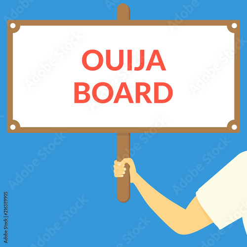 OUIJA BOARD. Hand holding wooden sign