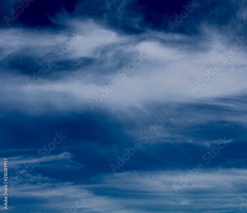 The streaky white cloudscape in the blue skies. 
