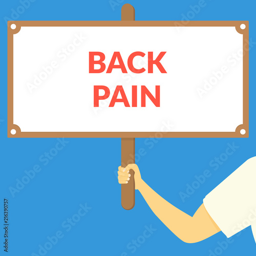 BACK PAIN. Hand holding wooden sign