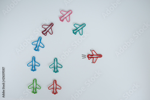 Business concept for group of stacked paperclip with another one red plane paperclip is point to another direction as a team leadership