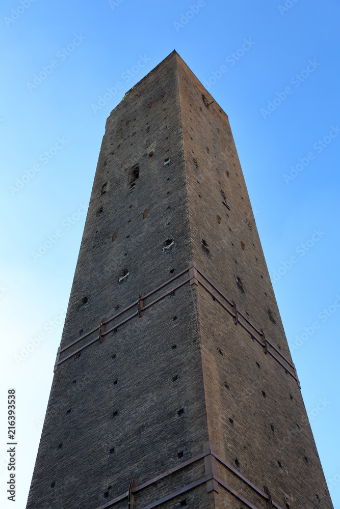 BOLOGNA, ITALY - JUNE 19, 2018: Part of the famous two towers in the city center. Built in the early 12th century
